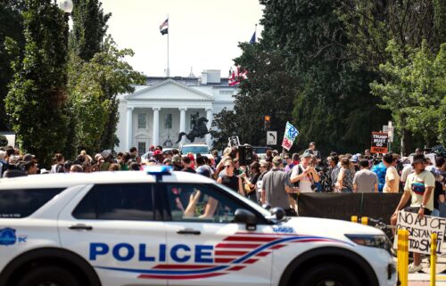A DC Metropolitan Police Department car is parked near a rally against the Trump Administration's federal takeover of the District of Columbia