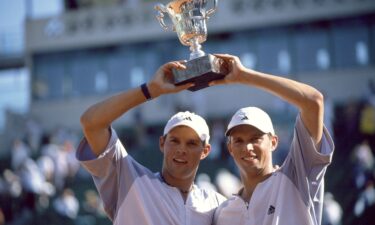 Michael Bryan and Bob Bryan lift the trophy after their win in the men's doubles final of the French Open in 2003.