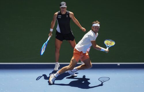 Raduacnu and Alcaraz celebrate winning a point.