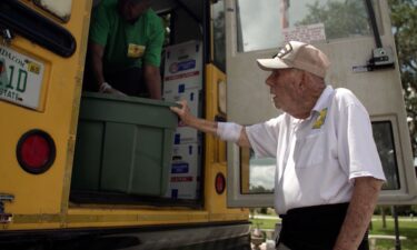 Bill Brown helps with a food delivery along the Children's Table weekly bus route.