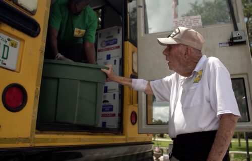 Bill Brown helps with a food delivery along the Children's Table weekly bus route.