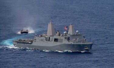 Amphibious transport dock USS New Orleans sails alongside a Japan Maritime Self Defense Force landing craft in June 2021.