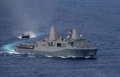 Amphibious transport dock USS New Orleans sails alongside a Japan Maritime Self Defense Force landing craft in June 2021.