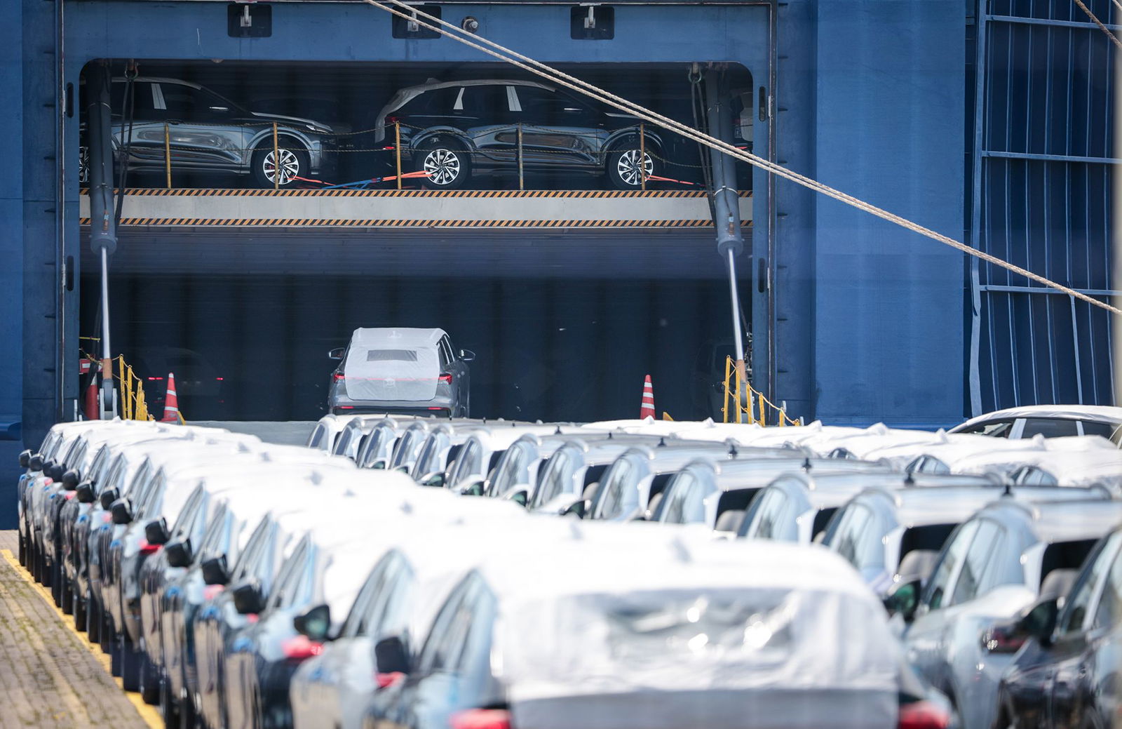 <i>Focke Strangmann/Getty Images via CNN Newsource</i><br/>Cars loaded onto a carrier ship in Germany for export. The lower tariffs on US imports from the EU won't go into effect as early as previously believed