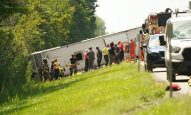 First responders work to rescue victims at the scene of a tour bus that crashed and rolled over on the New York State Thruway near Pembroke