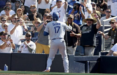 Shohei Ohtani celebrates with the San Diego Padres fan who had been heckling him throughout the game.