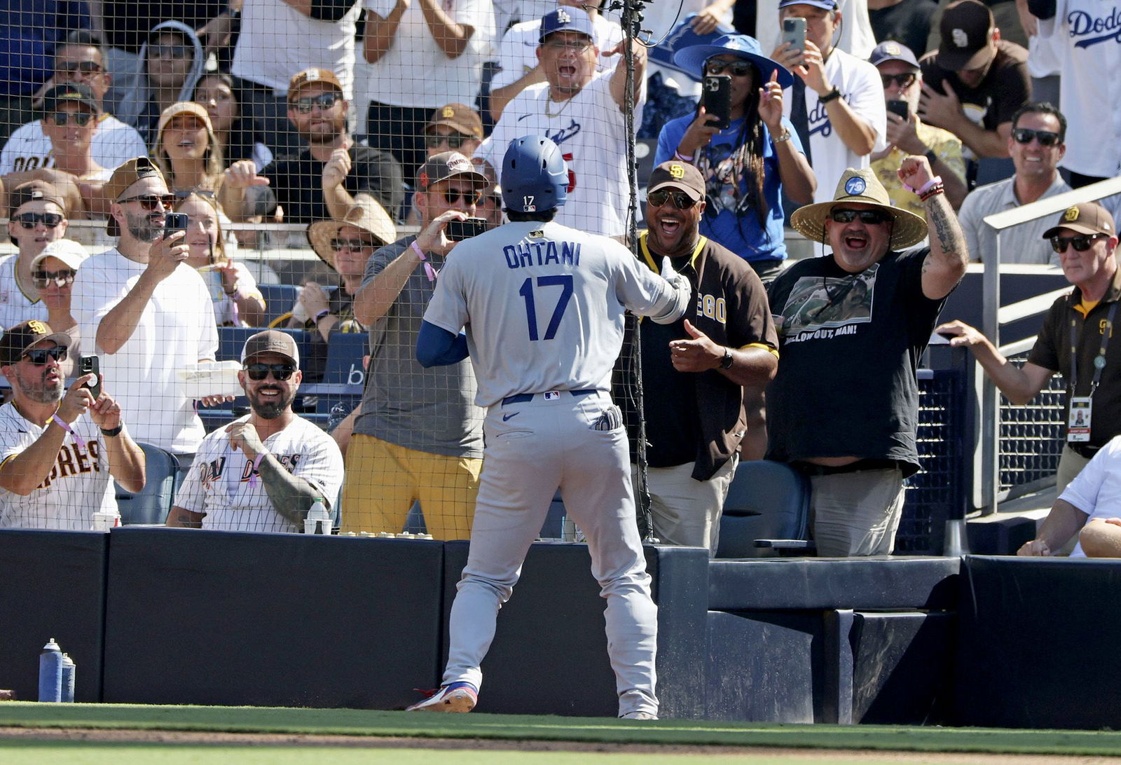 <i>Kyodo News/Getty Images via CNN Newsource</i><br/>Shohei Ohtani celebrates with the San Diego Padres fan who had been heckling him throughout the game.
