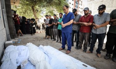 Dr. Mohammed Abu Salmiya performs funeral prayers for his family members killed in an Israeli airstrike on his family home in the Al Shati refugee camp