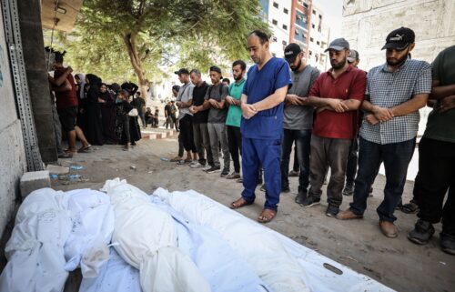 Dr. Mohammed Abu Salmiya performs funeral prayers for his family members killed in an Israeli airstrike on his family home in the Al Shati refugee camp