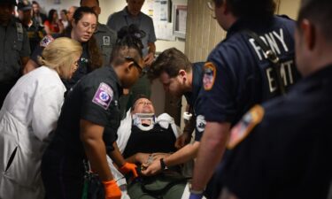 A journalist is tended to after being thrown to the ground and injured by federal agents at a New York City immigration court on Tuesday.