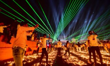 People in the Indian city of Ayodhya watch a laser show on the eve of Diwali in 2021.