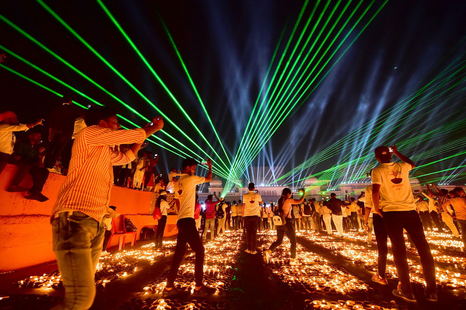 <i>Sanjay Kanojia/AFP/Getty Images via CNN Newsource</i><br/>People in the Indian city of Ayodhya watch a laser show on the eve of Diwali in 2021.