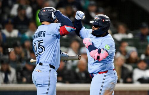Vladimir Guerrero Jr. (right) and Anthony Santander celebrate against the Mariners.