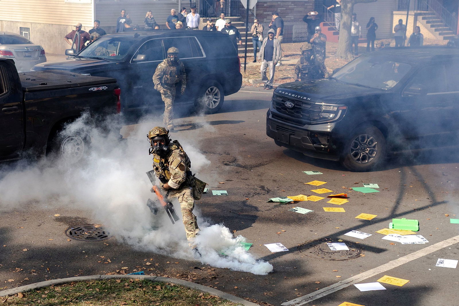 <i>Jim Vondruska/Reuters via CNN Newsource</i><br/>A federal agent prepares to throw a tear gas canister at community members during clashes on Chicago’s South Side on October 14.