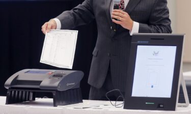 A Smartmatic representative demonstrates the company's voting system.