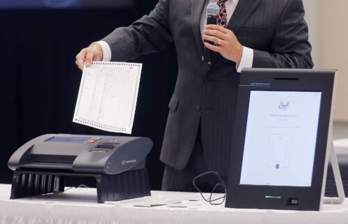 A Smartmatic representative demonstrates the company's voting system.