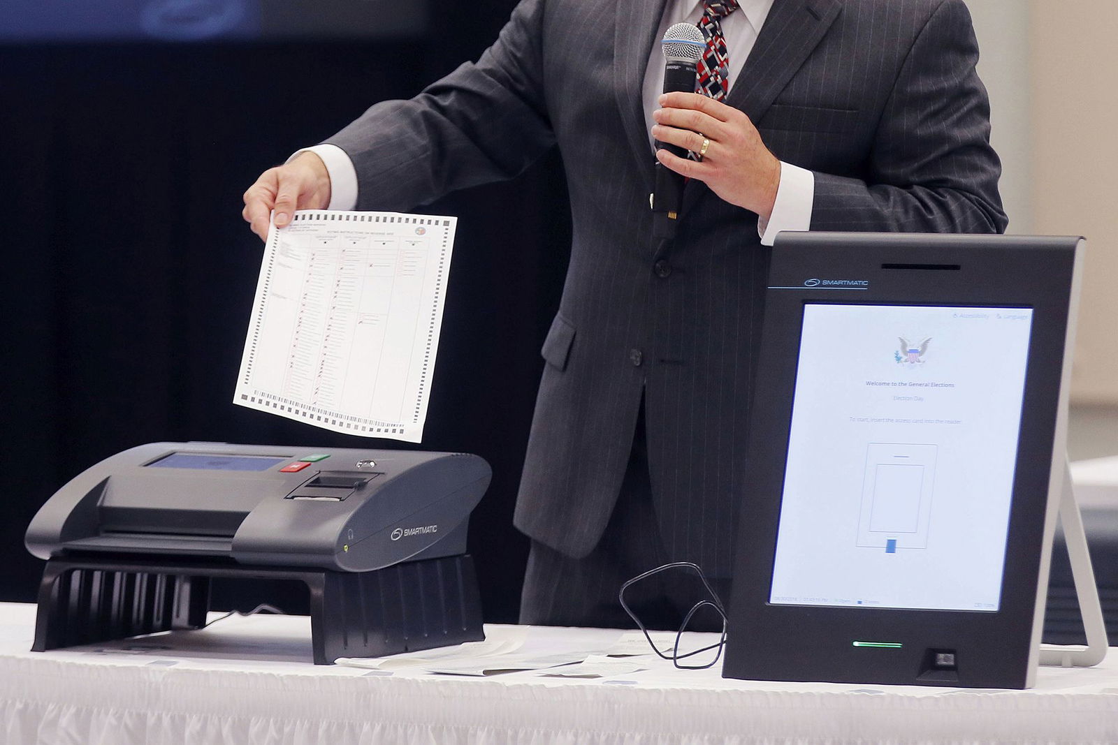 <i>Bob Andres/Atlanta Journal-Constitution/AP via CNN Newsource</i><br/>A Smartmatic representative demonstrates the company's voting system.