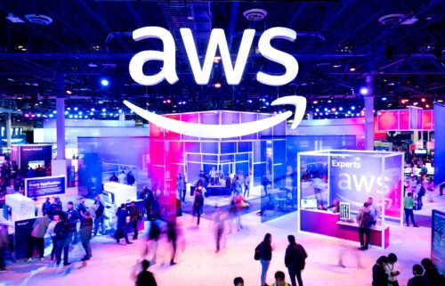Amazon Web Services logo is displayed at a conference. The service went down for several hours Monday.