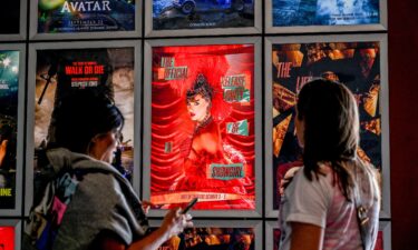 Fans take pictures in the lobby as they attend "Taylor Swift: The Official Release Party of a Showgirl" at AMC Montgomery 16 movie theater in Bethesda