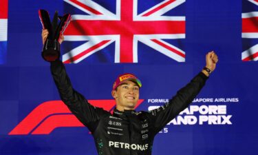 George Russell of Great Britain celebrates on the podium during the F1 Grand Prix of Singapore at Marina Bay Street Circuit.