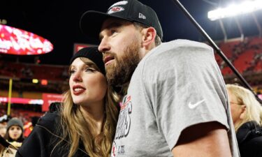 Tight end Travis Kelce #87 of the Kansas City Chiefs celebrates with Taylor Swift on the field after the AFC Championship game against the Buffalo Bills