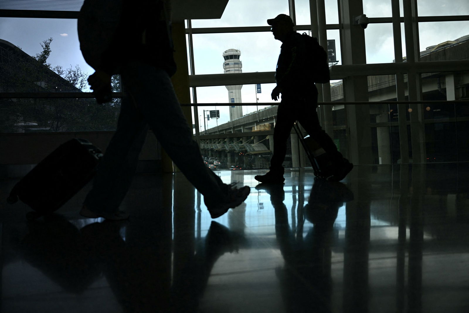 <i>Brendan Smialowski/AFP/Getty Images via CNN Newsource</i><br/>People walk through Reagan National Airport in Arlington