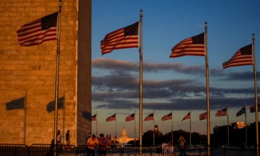 People watch the sunset from the Washington Monument ahead of the first supermoon of the year
