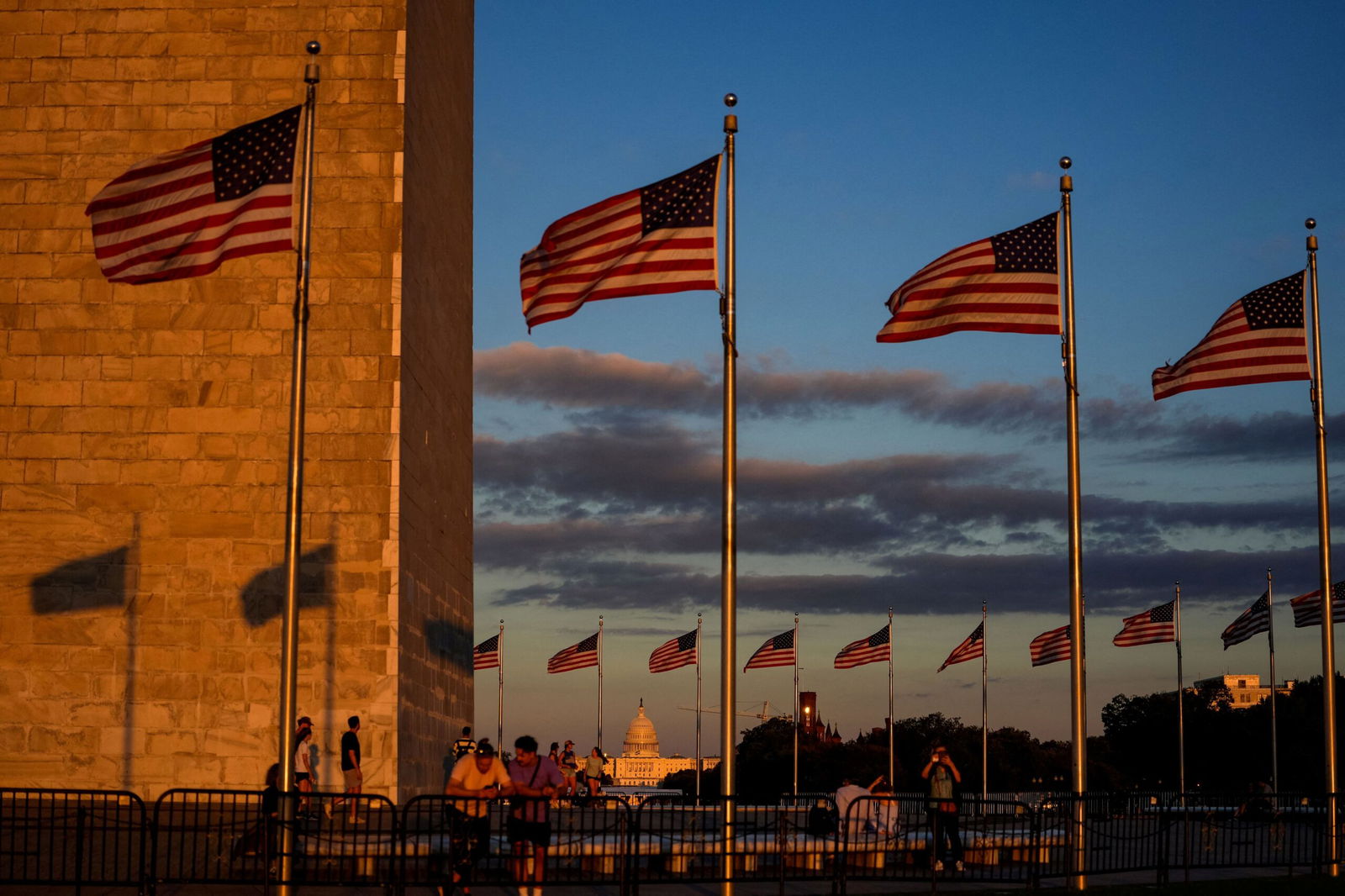 <i>Kent Nishimura/Reuters via CNN Newsource</i><br/>People watch the sunset from the Washington Monument ahead of the first supermoon of the year