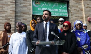 People walk along Roosevelt Avenue