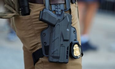The gun and badge of an FBI agent as he stands in the entertainment district Beale Street