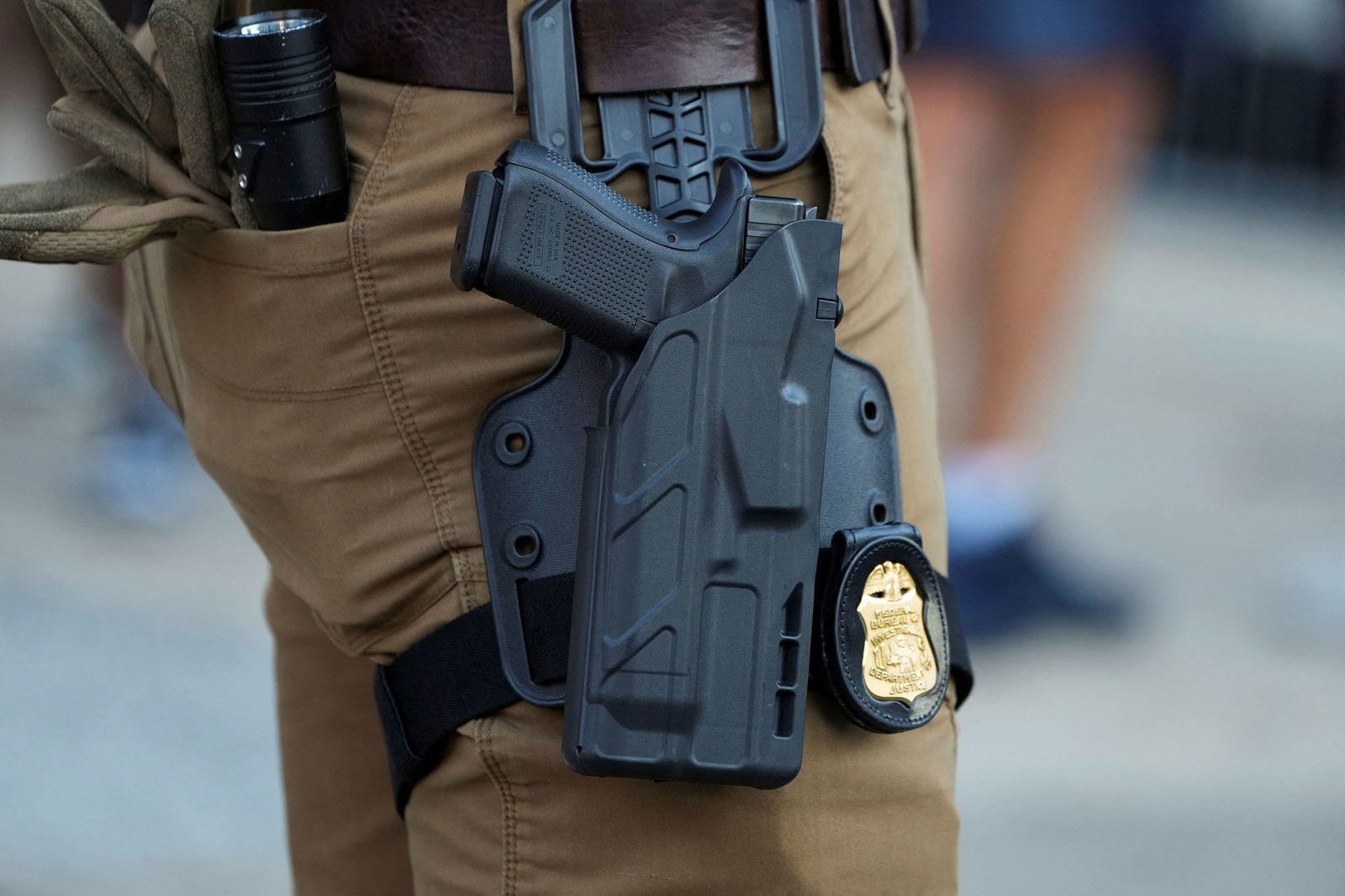 <i>Karen Pulfer Focht/Reuters/File via CNN Newsource</i><br/>The gun and badge of an FBI agent as he stands in the entertainment district Beale Street
