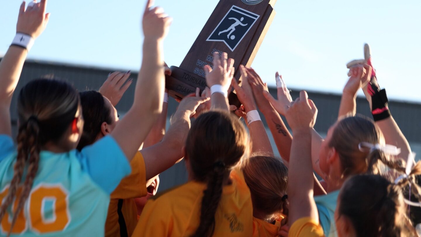 Missouri Western women's soccer players mob the MIAA Tournament Championship trophy after defeating Central Oklahoma 2-1 in overtime to win their first MIAA Tournament Championship in program history on Saturday in Wichita, Kansas. 