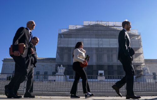 Members of the public walk outside the U.S. Supreme Court to attend oral arguments on U.S. President Donald Trump's bid to preserve sweeping tariffs after lower courts ruled that Trump overstepped his authority