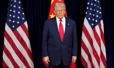 US President Donald Trump prepares to greet Chinese President Xi Jinping ahead of a bilateral meeting at Gimhae Air Base in Busan