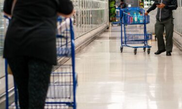 An election worker processes a container of mail-in ballots at the Salt Lake County election offices in Salt Lake City
