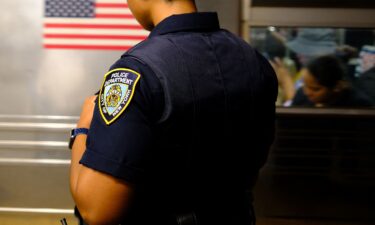 A New York Police Department officer patrols on a subway platform in New York on August 23.