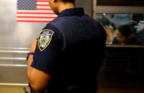 A New York Police Department officer patrols on a subway platform in New York on August 23.