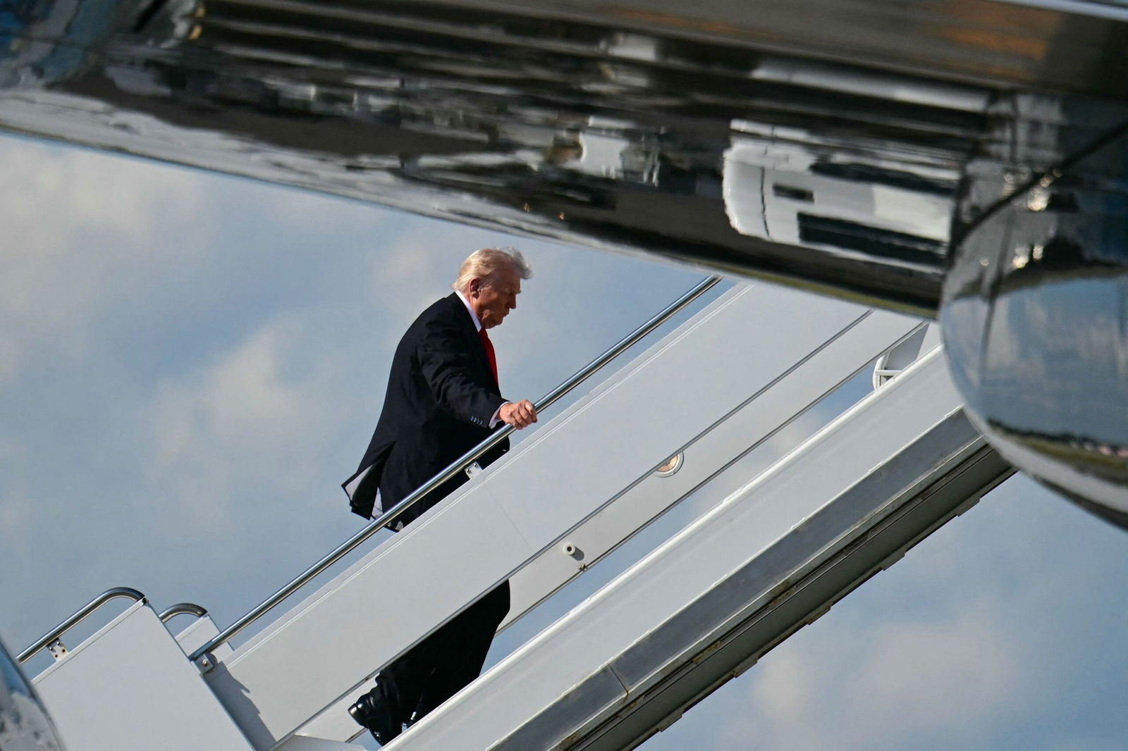 <i>Jim Watson/AFP/Getty Images via CNN Newsource</i><br/>President Donald Trump boards Air Force One at Palm Beach International Airport in West Palm Beach
