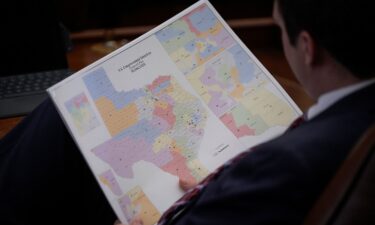 A representative looks at a congressional redistricting map during debate of a congressional redistricting plan in the House Chamber at the Texas State Capitol in Austin