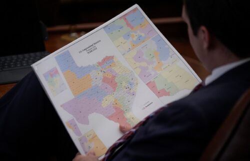 A representative looks at a congressional redistricting map during debate of a congressional redistricting plan in the House Chamber at the Texas State Capitol in Austin