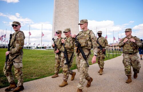 The Washington Monument is visible as armed members of the National Guard patrol the National Mall on August 27 in Washington