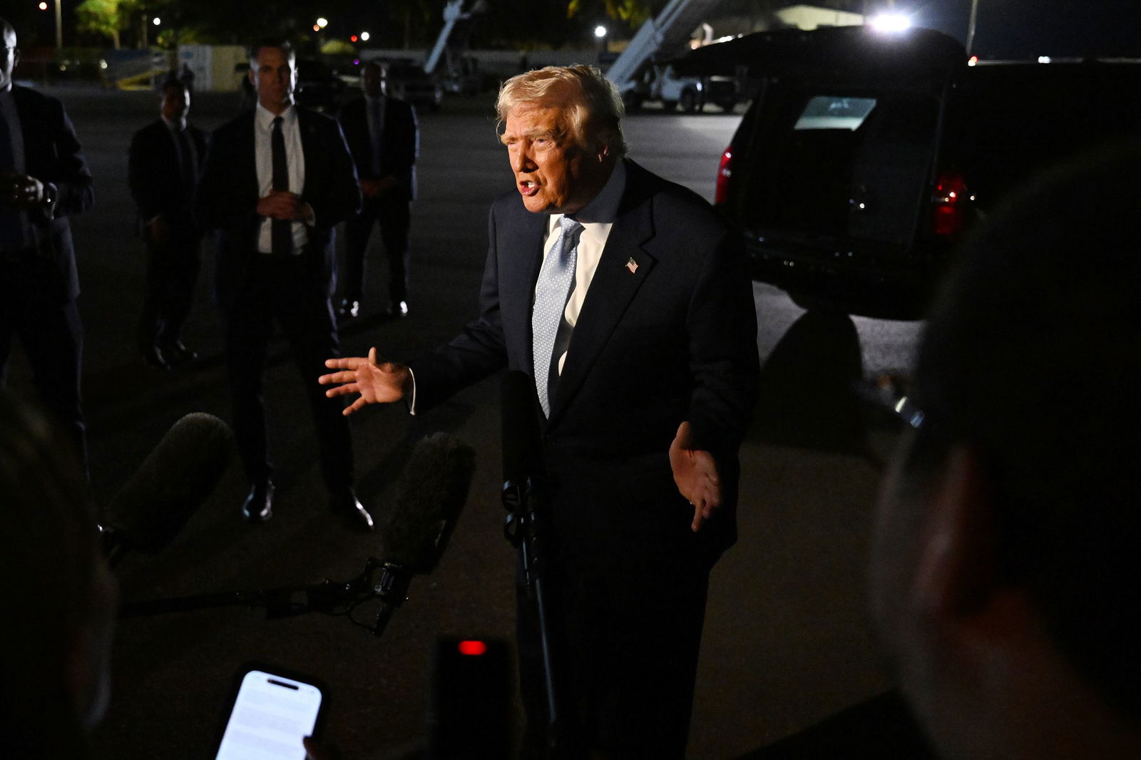 President Donald Trump speaks to reporters before boarding Air Force One on November 16.