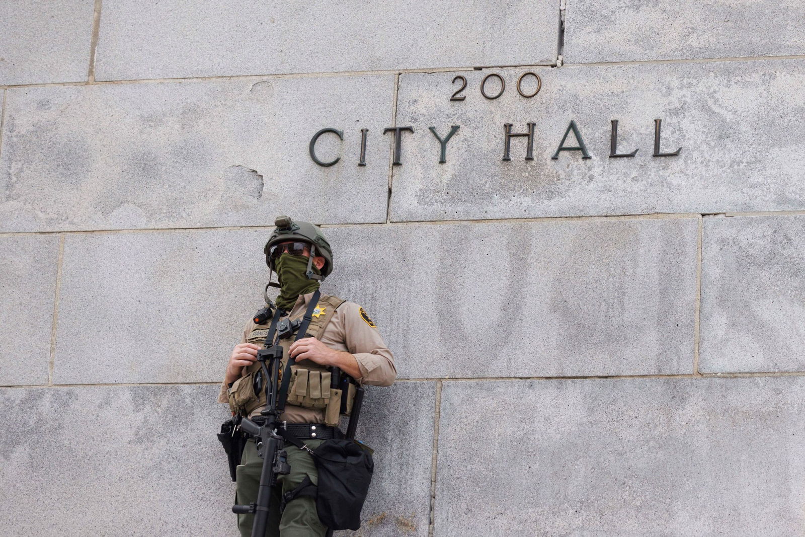 <i>John Rudoff/Sipa/AP via CNN Newsource</i><br/>A law enforcement officer stands as people filled the streets of downtown Los Angeles in a massive 'No Kings' march