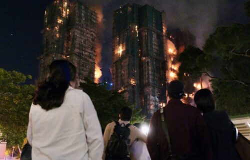 Victims are evacuated from the scene of a devastating fire which broke out at a karaoke bar in Hong Kong in January 1997.