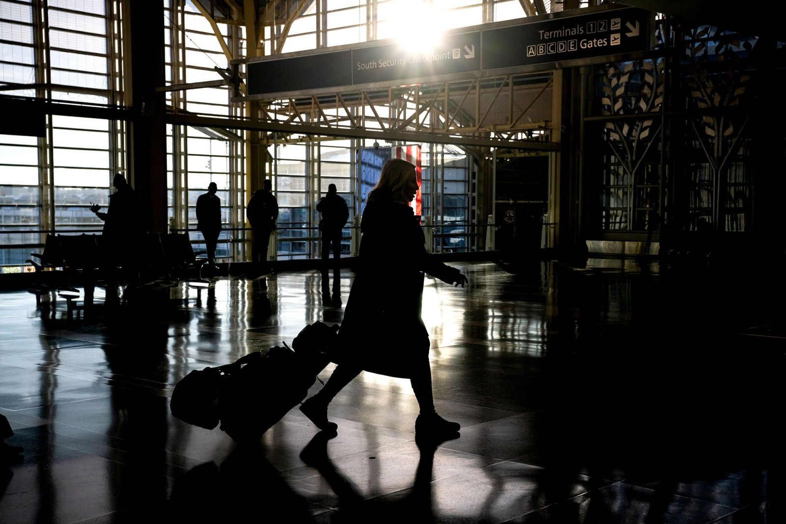 <i>Graeme Sloan/Bloomberg/Getty Images via CNN Newsource</i><br/>A traveler walks through Ronald Reagan Washington National Airport in Arlington