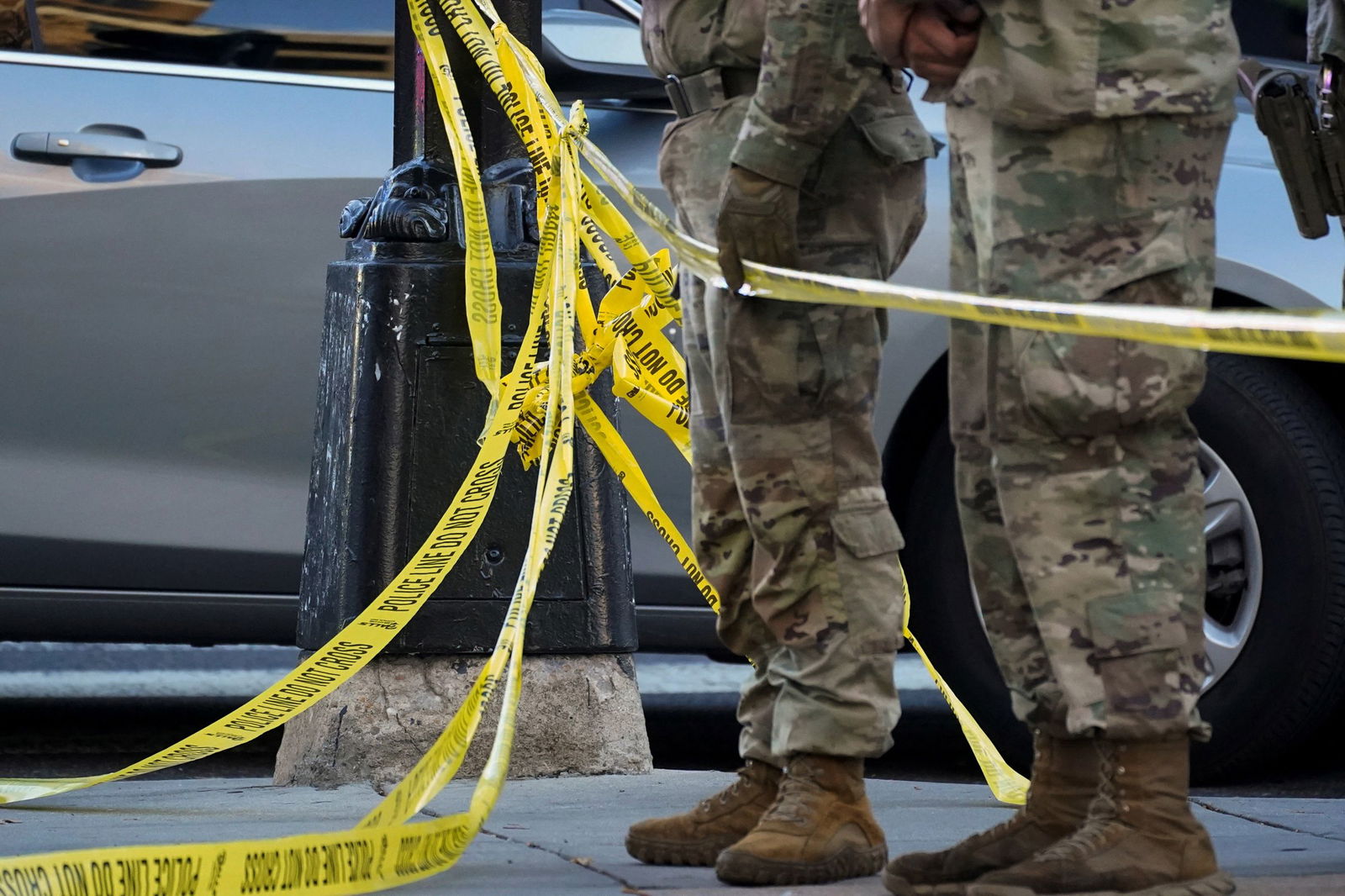 <i>Nathan Howard/Reuters via CNN Newsource</i><br/>National Guard members stand together behind yellow tape