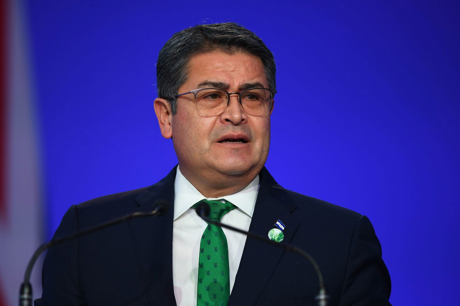 <i>Andy Buchanan/Pool/Getty Images via CNN Newsource</i><br/>Juan Orlando Hernández presents his national statement during day two of COP26 at SECC on November 1