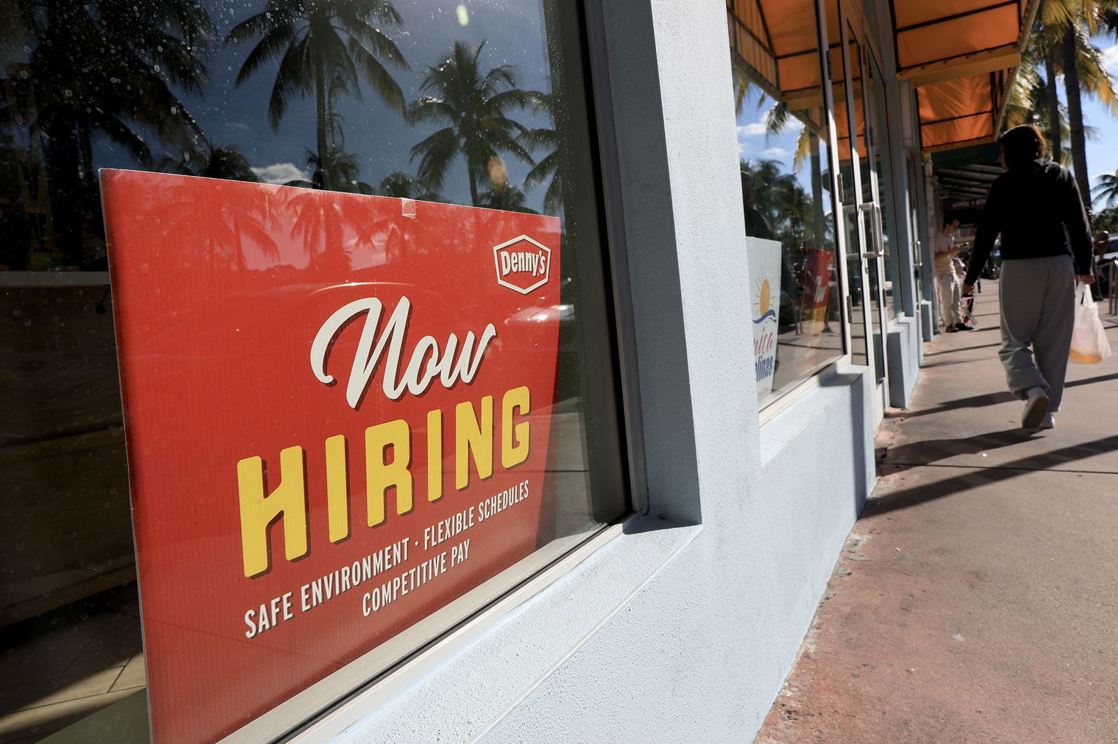 <i>Joe Raedle/Getty Images via CNN Newsource</i><br/>A 'Now Hiring' sign sits in the window of a Denny's restaurant on November 19 in Miami.